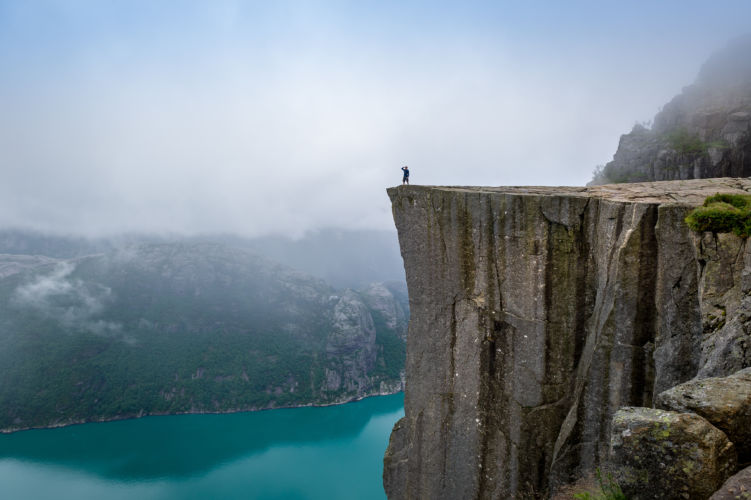 Data Migrations Shouldn't Be Cliffhangers blog post: tourist is standing on the of a cliff