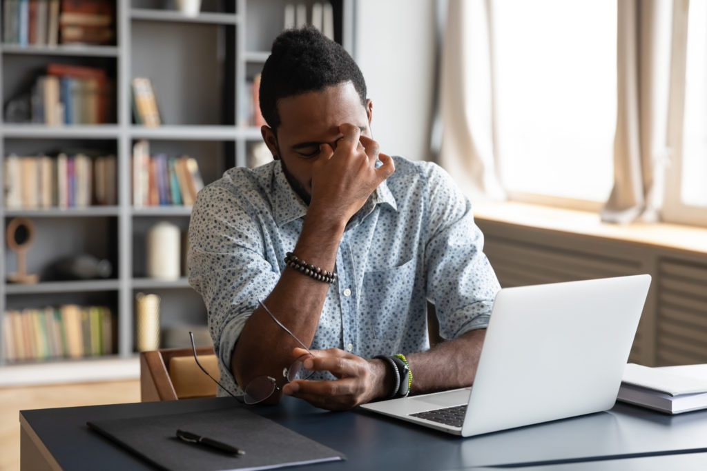 Virtual office worker stressed at computer