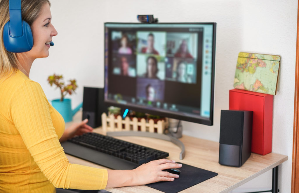 Virtual office worker smiles as she participates in a call with her custom software development team