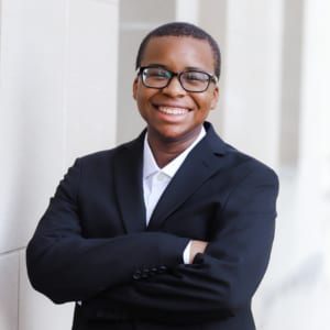 Male Digital Maelstrom member smiling at camera with arms crossed