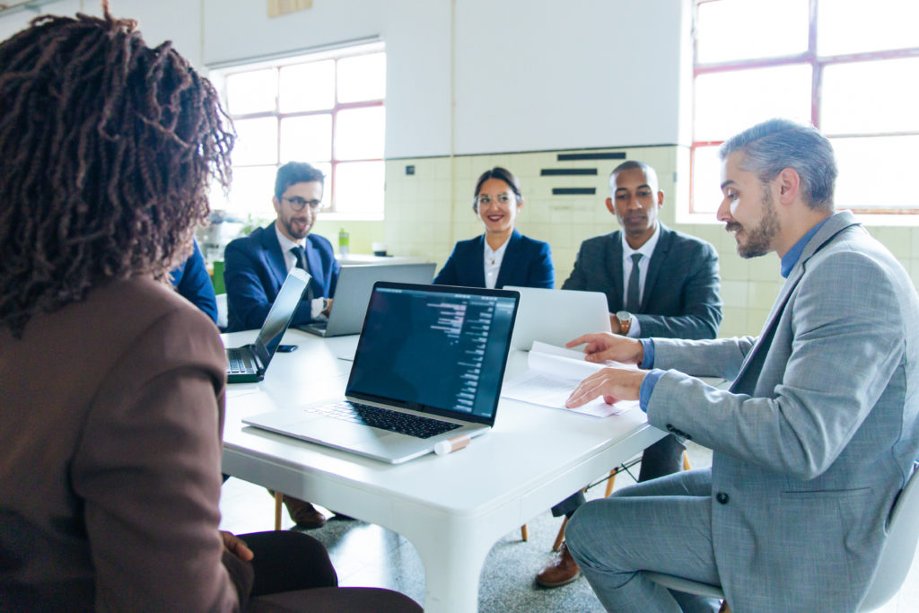 Two teams of experts meeting together on their cloud application development project